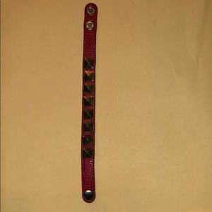 Red bracelet with gold studs